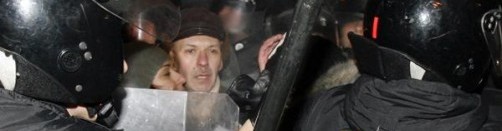 Riot police disperse opposition supporters during a rally near the Parliament building in central Minsk